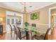 Bright dining room with large glass table, comfortable seating, and hardwood floors at 676 Dunblane Dr, Winter Park, FL 32792