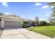 Well-maintained home with an attached garage, landscaped front yard, and charming curb appeal at 676 Dunblane Dr, Winter Park, FL 32792