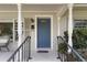 Inviting front entrance featuring a blue door, white columns, and a cozy seating area at 676 Dunblane Dr, Winter Park, FL 32792