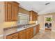 A kitchen features updated granite countertops, wood cabinets, and stainless steel appliances offering a blend of style at 676 Dunblane Dr, Winter Park, FL 32792