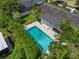 Aerial view of a private backyard pool oasis, enclosed by a tall, manicured hedge for ultimate seclusion at 676 Dunblane Dr, Winter Park, FL 32792