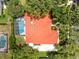 Aerial view of home with a red tile roof, screened pool, and lush landscaping at 718 Glen Eagle Dr, Winter Springs, FL 32708
