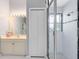 Bathroom featuring modern shower with clear glass doors, neutral tilework, and built in shelving at 718 Glen Eagle Dr, Winter Springs, FL 32708