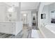Luxurious bathroom with quartz countertop, soaking tub, decorative mirrors and white cabinets at 718 Glen Eagle Dr, Winter Springs, FL 32708