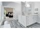 Well-lit bathroom with quartz countertop, modern finishes and a view into the main bedroom at 718 Glen Eagle Dr, Winter Springs, FL 32708