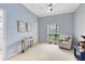 A bright bedroom provides a relaxing retreat with a chair and side table, plus a view to outside at 718 Glen Eagle Dr, Winter Springs, FL 32708
