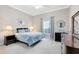 Cozy bedroom with a plush bed, bedside lamps, and a view of the outside at 718 Glen Eagle Dr, Winter Springs, FL 32708