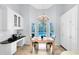 Bright dining area features a wooden table, a chandelier, views of the pool, and white cabinets for storage at 718 Glen Eagle Dr, Winter Springs, FL 32708