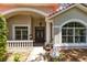 Charming home entrance with arched windows, brick walkway, and manicured landscaping offers curb appeal at 718 Glen Eagle Dr, Winter Springs, FL 32708