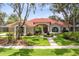Beautiful home featuring lush landscaping, a front lawn fountain, and a classic tiled roof, offering great curb appeal at 718 Glen Eagle Dr, Winter Springs, FL 32708