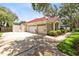 Spacious three car garage with plenty of parking and a well-manicured lawn at 718 Glen Eagle Dr, Winter Springs, FL 32708