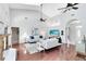 Bright living room with wood floors, vaulted ceiling, a fireplace, and views of the kitchen at 718 Glen Eagle Dr, Winter Springs, FL 32708