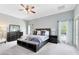Serene main bedroom featuring neutral tones, a ceiling fan, and an ensuite bathroom at 718 Glen Eagle Dr, Winter Springs, FL 32708