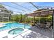 Private screened pool and spa with a gazebo featuring an outdoor dining set for the ultimate backyard enjoyment at 718 Glen Eagle Dr, Winter Springs, FL 32708