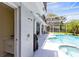 Covered outdoor shower and sink area next to the screened in pool with hot tub at 718 Glen Eagle Dr, Winter Springs, FL 32708
