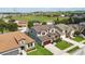 Aerial view showing a two-story home with a brown roof, red door, and a beautifully landscaped yard at 731 Arbor Pointe Ave, Minneola, FL 34715