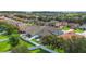 An aerial view of a neighborhood with well-maintained homes and lush green lawns, showcasing a Gathering-friendly environment at 731 Arbor Pointe Ave, Minneola, FL 34715