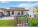 Fenced backyard features a play set, green grass, and a covered patio for outdoor enjoyment at 731 Arbor Pointe Ave, Minneola, FL 34715