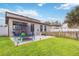 Grassy backyard features a trampoline and a concrete patio area for entertaining and relaxing outdoors at 731 Arbor Pointe Ave, Minneola, FL 34715