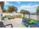 Fenced backyard with green grass, a trampoline, and a playset, perfect for outdoor activities and fun at 731 Arbor Pointe Ave, Minneola, FL 34715