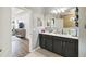 Bathroom boasts double vanity with dark cabinets and a well lit mirror at 731 Arbor Pointe Ave, Minneola, FL 34715
