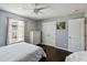 Comfortable bedroom featuring dark floors, a ceiling fan and closet at 731 Arbor Pointe Ave, Minneola, FL 34715