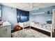 This bedroom includes hardwood floors, light blue walls, and an outerspace theme at 731 Arbor Pointe Ave, Minneola, FL 34715