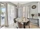 Cozy dining area featuring a marble table and contemporary lighting fixture at 731 Arbor Pointe Ave, Minneola, FL 34715