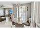 Dining area with a round marble table and modern chandelier, adjacent to the living room at 731 Arbor Pointe Ave, Minneola, FL 34715