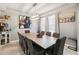 Bright dining room featuring modern lighting, a long dining table, and artwork at 731 Arbor Pointe Ave, Minneola, FL 34715