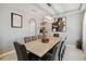 Spacious dining room with modern chandelier, large dining table and decor shelving at 731 Arbor Pointe Ave, Minneola, FL 34715