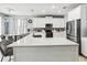 Spacious kitchen with stainless appliances, white cabinets, and an island with bar stool seating at 731 Arbor Pointe Ave, Minneola, FL 34715