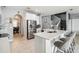 Bright kitchen features white cabinets, stainless steel appliances, large island with seating at 731 Arbor Pointe Ave, Minneola, FL 34715