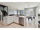 Open-concept kitchen with stainless steel appliances, white cabinetry, view to Gathering room at 731 Arbor Pointe Ave, Minneola, FL 34715