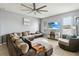 Comfortable living room with large sectional sofa, ceiling fan, and entertainment center at 731 Arbor Pointe Ave, Minneola, FL 34715