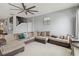 Cozy living room featuring a large sectional sofa, tile flooring, neutral paint, and access to the stairway at 731 Arbor Pointe Ave, Minneola, FL 34715