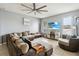 Spacious living room with a large sectional sofa, tile flooring, a ceiling fan, and a modern fireplace at 731 Arbor Pointe Ave, Minneola, FL 34715