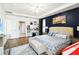 Spacious main bedroom with accent wall, tray ceiling and hardwood floors at 731 Arbor Pointe Ave, Minneola, FL 34715