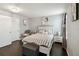 Cozy bedroom with striped bedding, wood floors, and matching nightstands at 731 Arbor Pointe Ave, Minneola, FL 34715