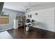 Spacious office area with hardwood flooring, a ceiling fan, and white shelving at 731 Arbor Pointe Ave, Minneola, FL 34715