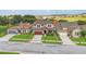 Aerial view of a charming two-story home with well-maintained landscaping and a red garage door at 731 Arbor Pointe Ave, Minneola, FL 34715