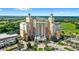 Aerial view of a beautiful resort with palm trees, lush landscaping and pristine grounds at 7650 Whisper Way # 104, Reunion, FL 34747