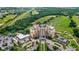 Aerial view capturing the elegance of a tall hotel building with meticulously landscaped grounds and ample parking at 7650 Whisper Way # 104, Reunion, FL 34747