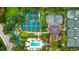 Aerial view of community facilities featuring tennis courts, pool, mini-golf and clubhouse at 7650 Whisper Way # 104, Reunion, FL 34747