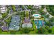 Aerial view of community amenities featuring tennis courts, pool, playground and parking at 7650 Whisper Way # 104, Reunion, FL 34747