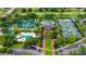 Aerial view of tennis and pickle ball courts, playground, community pool and parking at 7650 Whisper Way # 104, Reunion, FL 34747