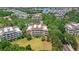 Overhead view of multi-Gathering residences set amidst verdant trees and landscaping at 7650 Whisper Way # 104, Reunion, FL 34747
