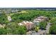 Aerial view of condo building surrounded by trees and community golf course at 7650 Whisper Way # 104, Reunion, FL 34747