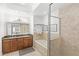 Bathroom features a double vanity, soaking tub, and shower with glass enclosure at 7650 Whisper Way # 104, Reunion, FL 34747