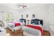 Bright bedroom with hardwood floors, two twin beds, and a window at 7650 Whisper Way # 104, Reunion, FL 34747